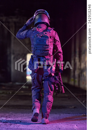 Tactical Medic Soldier Walking Through Urban Tunnel At Night With Helmet And Rifle Tactical Medic Soldier Walking Through Urban Tunnel At Night With Helmet And Rifle 142918246