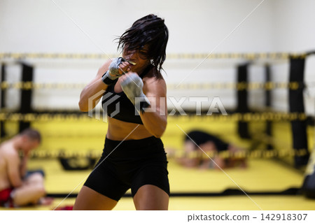 Female Boxer Training Intensity in Boxing Ring During Sparring Session and Fitness Workout Female Boxer Training Intensity in Boxing Ring During Sparring Session and Fitness Workout 142918307