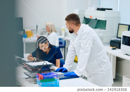 Medical professionals collaborating in a laboratory setting during a research project Medical professionals collaborating in a laboratory setting during a research project 142918308