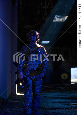 Soldier In Tactical Gear Walking Through Dark Abandoned Building With Dramatic Sunlight Beam Soldier In Tactical Gear Walking Through Dark Abandoned Building With Dramatic Sunlight Beam 142918311
