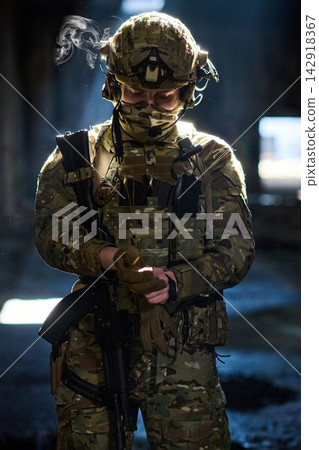 Camouflaged Soldier In Tactical Gear Preparing For Mission With Helmet Rifle And Gloves Camouflaged Soldier In Tactical Gear Preparing For Mission With Helmet Rifle And Gloves 142918367