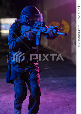 SWAT Officer in Tactical Gear Aiming Rifle During Night Urban Operation With Protective Helmet and Visor SWAT Officer in Tactical Gear Aiming Rifle During Night Urban Operation With Protective Helmet and Visor 142918512