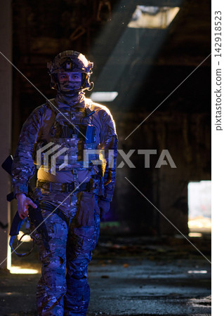 Armed Soldier in Camouflage Tactical Gear Walking Through Dim Urban Ruins With Dramatic Light Armed Soldier in Camouflage Tactical Gear Walking Through Dim Urban Ruins With Dramatic Light 142918523