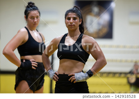 Female Boxers Training in Gym Ring Showing Strength Confidence and Determination Female Boxers Training in Gym Ring Showing Strength Confidence and Determination 142918528