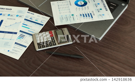Business Reports with Laptop and Calculator on Wooden Office Desk 3d render. Business Reports with Laptop and Calculator on Wooden Office Desk 3d render. 142918636