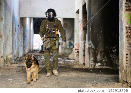 Tactical Soldier and Military K9 Patrol an Abandoned Urban Building During Training Operation Tactical Soldier and Military K9 Patrol an Abandoned Urban Building During Training Operation 142918706