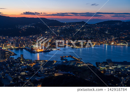 The early morning view from Sayama of Nagasaki city and Nagasaki harbor, with its gradient of colors reflecting the rising sun. The early morning view from Sayama of Nagasaki city and Nagasaki harbor, with its gradient of colors reflecting the rising sun. 142918784