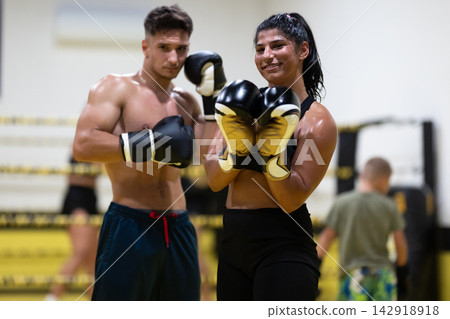 Confident Female Boxer And Male Partner During Boxing Training And Sparring Session In Gym 142918918
