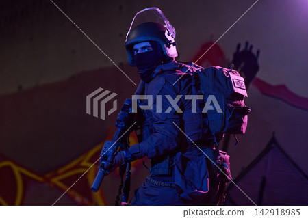 Tactical Medic Soldier In Night Urban Raid Wearing Helmet, Balaclava, Tactical Gear And Rifle Tactical Medic Soldier In Night Urban Raid Wearing Helmet, Balaclava, Tactical Gear And Rifle 142918985