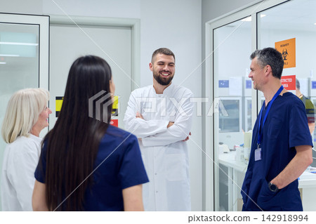 Healthcare team discusses patient care in modern clinic setting during daytime hours Healthcare team discusses patient care in modern clinic setting during daytime hours 142918994