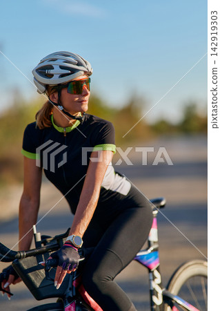 Fit Woman Cyclist On Road Bike Wearing Helmet And Sunglasses Enjoying Outdoor Cycling Workout Fit Woman Cyclist On Road Bike Wearing Helmet And Sunglasses Enjoying Outdoor Cycling Workout 142919303