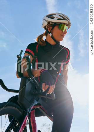 Female Cyclist On Road Bike Wearing Helmet And Sunglasses Training Outdoors In Sunny Weather Female Cyclist On Road Bike Wearing Helmet And Sunglasses Training Outdoors In Sunny Weather 142919350