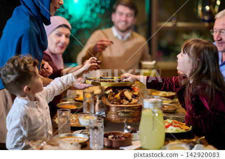 Multigenerational Family Sharing Dates At Festive Ramadan Iftar Dinner Around Table Multigenerational Family Sharing Dates At Festive Ramadan Iftar Dinner Around Table 142920083