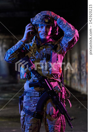Tactical Soldier In Night Urban Operation Wearing Helmet And Combat Gear With Rifle Tactical Soldier In Night Urban Operation Wearing Helmet And Combat Gear With Rifle 142920215