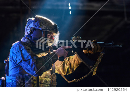 Tactical Soldier Aiming Assault Rifle in Low Light Combat Training With Camouflage Gear and Helmet Tactical Soldier Aiming Assault Rifle in Low Light Combat Training With Camouflage Gear and Helmet 142920264