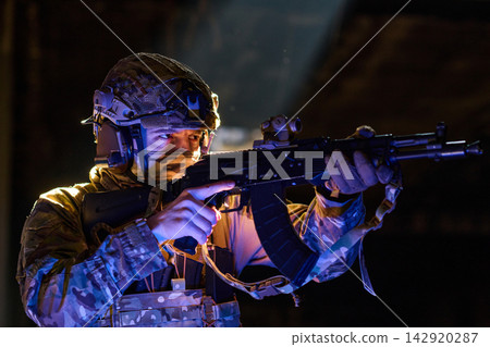 Soldier Aiming Assault Rifle in Tactical Gear During Low-Light Operation with Night Vision Mount Soldier Aiming Assault Rifle in Tactical Gear During Low-Light Operation with Night Vision Mount 142920287