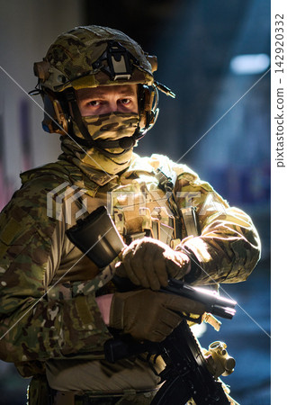 Tactical Soldier in Camouflage Uniform Holding Rifle With Helmet and Night Vision Gear in Urban Operation Tactical Soldier in Camouflage Uniform Holding Rifle With Helmet and Night Vision Gear in Urban Operation 142920332