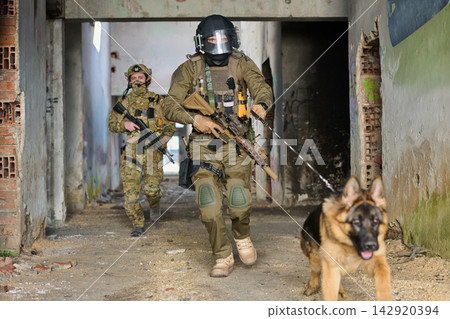 Tactical Military Team With K9 Dog Clearing Abandoned Urban Building During Training Operation Tactical Military Team With K9 Dog Clearing Abandoned Urban Building During Training Operation 142920394