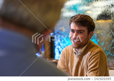 Friendly Business Conversation Between Young Man And Colleague During Casual Meeting At Office Cafe Friendly Business Conversation Between Young Man And Colleague During Casual Meeting At Office Cafe 142920395