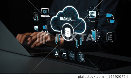 A digital representation of cloud backup technology illustrates data security, management, and recovery concepts with a laptop and user interacting with the interface. Sigmoid A digital representation of cloud backup technology illustrates data security, management, and recovery concepts with a laptop and user interacting with the interface. Sigmoid 142920734