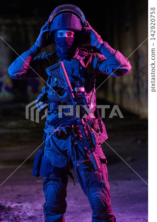 Tactical Soldier in Night Urban Environment Wearing Helmet and Ballistic Gear With Assault Rifle Tactical Soldier in Night Urban Environment Wearing Helmet and Ballistic Gear With Assault Rifle 142920758