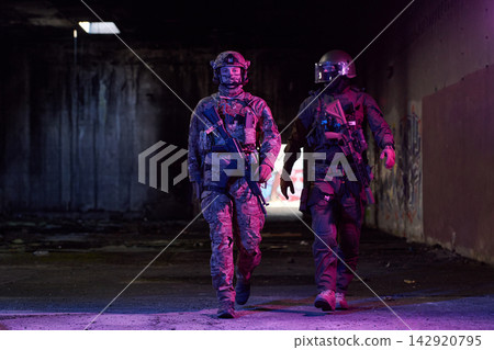 Two Tactical Soldiers On Urban Night Patrol In Abandoned Building With Rifles And Gear 142920795