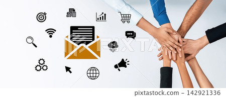 Collaborative Teamwork with Hands Stacking Over Email Icons and Digital Marketing Symbols Representing Communication and Business Strategy Concepts. Glyphic Collaborative Teamwork with Hands Stacking Over Email Icons and Digital Marketing Symbols Representing Communication and Business Strategy Concepts. Glyphic 142921336