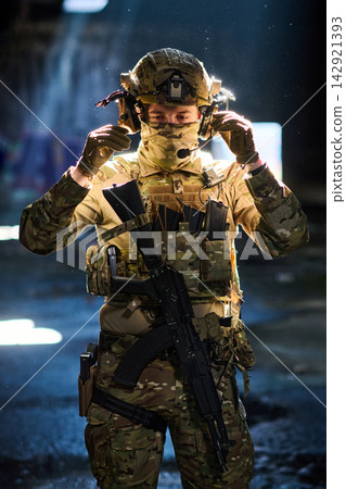 Soldier In Full Tactical Gear With Rifle And Headset Preparing For Night Operation 142921393
