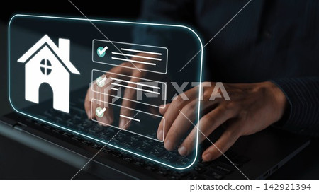Hands typing on laptop in dark environment with holographic home icon and checklist indicating digital real estate management and online application process Gluon Hands typing on laptop in dark environment with holographic home icon and checklist indicating digital real estate management and online application process Gluon 142921394