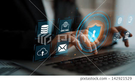 Business professional using laptop to secure data with digital technology symbols, illustrating the importance of cybersecurity in the modern workplace Gluon Business professional using laptop to secure data with digital technology symbols, illustrating the importance of cybersecurity in the modern workplace Gluon 142921529