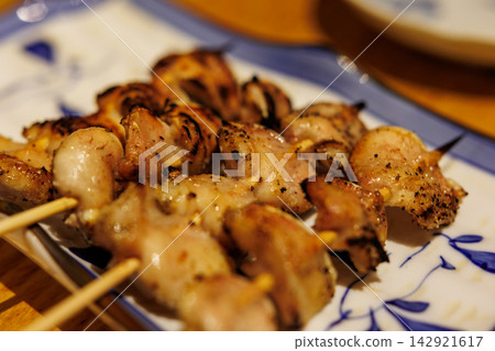 Chicken tail skewers at an izakaya (Japanese pub) | A fragrant grilled chicken dish Chicken tail skewers at an izakaya (Japanese pub) | A fragrant grilled chicken dish 142921617