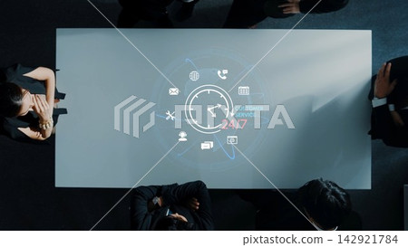 Modern Business Meeting with Digital Customer Service Concept on Table Displaying 24-7 Availability Icons and Professional Teammates Engaged in Discussion. Entropy Modern Business Meeting with Digital Customer Service Concept on Table Displaying 24-7 Availability Icons and Professional Teammates Engaged in Discussion. Entropy 142921784