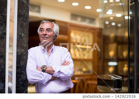 Middle Eastern man in jewelry store during wedding ring shopping with family and friends Middle Eastern man in jewelry store during wedding ring shopping with family and friends 142922016