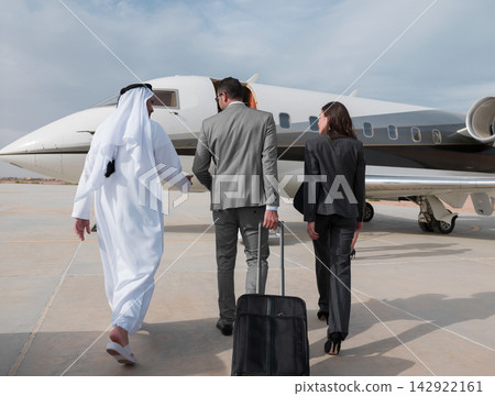 Middle Eastern business team boarding private jet for international corporate travel and luxury transport Middle Eastern business team boarding private jet for international corporate travel and luxury transport 142922161