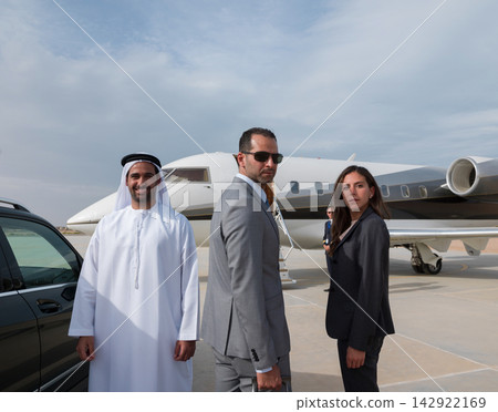 Business team boarding private jet at airport with luxury car and professional executives Business team boarding private jet at airport with luxury car and professional executives 142922169