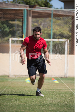 Middle Eastern man sprinting during outdoor CrossFit training session at open space fitness gym Middle Eastern man sprinting during outdoor CrossFit training session at open space fitness gym 142922416