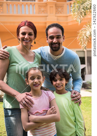 Modern Middle Eastern family smiling together in their backyard home enjoying time with children Modern Middle Eastern family smiling together in their backyard home enjoying time with children 142922660