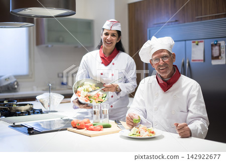 Middle Eastern family chefs preparing Eid Ramadan iftar dinner together in a modern home kitchen Middle Eastern family chefs preparing Eid Ramadan iftar dinner together in a modern home kitchen 142922677