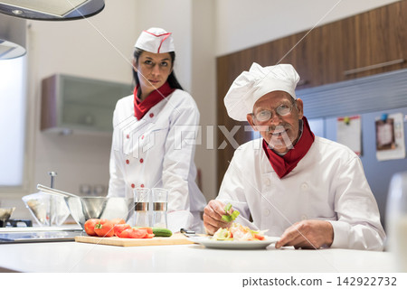 Middle Eastern family chefs preparing Eid and Ramadan iftar dinner together in modern home kitchen Middle Eastern family chefs preparing Eid and Ramadan iftar dinner together in modern home kitchen 142922732