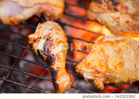 Grilled chicken on a charcoal barbecue for Eid Ramadan iftar family dinner at modern home Grilled chicken on a charcoal barbecue for Eid Ramadan iftar family dinner at modern home 142922862