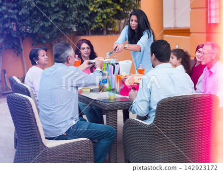 Middle Eastern Arab family enjoying an outdoor patio meal and casual gathering with friends and relatives Middle Eastern Arab family enjoying an outdoor patio meal and casual gathering with friends and relatives 142923172