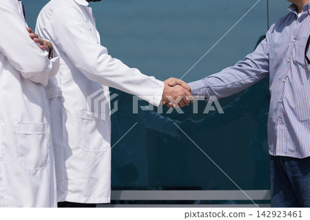 Doctors shake hands with patient outside modern Middle Eastern eye hospital clinic in Egypt Doctors shake hands with patient outside modern Middle Eastern eye hospital clinic in Egypt 142923461