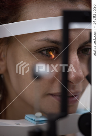Patient receiving slit-lamp eye examination in modern Middle Eastern eye clinic in Egypt with medical team Patient receiving slit-lamp eye examination in modern Middle Eastern eye clinic in Egypt with medical team 142923550
