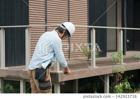 Site supervisor inspecting the deck of a used house 142923716
