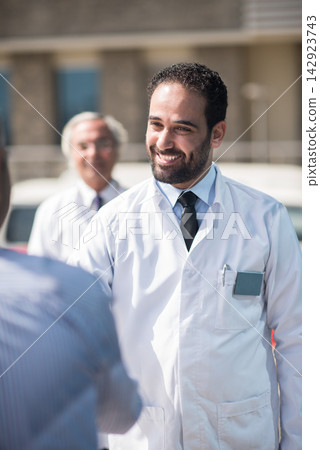 Eye hospital doctors meeting outside a modern Middle Eastern clinic in Egypt discussing surgery plans Eye hospital doctors meeting outside a modern Middle Eastern clinic in Egypt discussing surgery plans 142923743