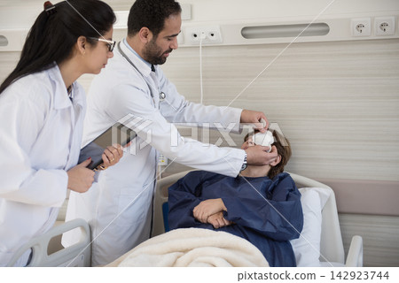 Ophthalmology team treating a patient in a modern Middle Eastern eye hospital clinic in Egypt Ophthalmology team treating a patient in a modern Middle Eastern eye hospital clinic in Egypt 142923744