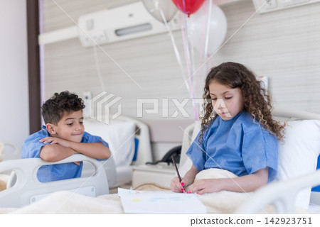 Two pediatric patients in a Middle Eastern eye hospital ward drawing and resting with balloons Two pediatric patients in a Middle Eastern eye hospital ward drawing and resting with balloons 142923751