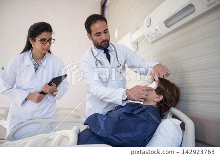 Middle Eastern doctors examining patient in an eye hospital clinic before ophthalmic surgery in Egypt Middle Eastern doctors examining patient in an eye hospital clinic before ophthalmic surgery in Egypt 142923763