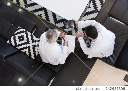 Doctors review patient X-rays on a tablet during a meeting at a modern eye hospital in Egypt Doctors review patient X-rays on a tablet during a meeting at a modern eye hospital in Egypt 142923806