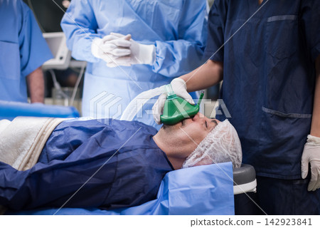 Medical team preparing patient for eye surgery in a modern Middle Eastern hospital clinic in Egypt Medical team preparing patient for eye surgery in a modern Middle Eastern hospital clinic in Egypt 142923841